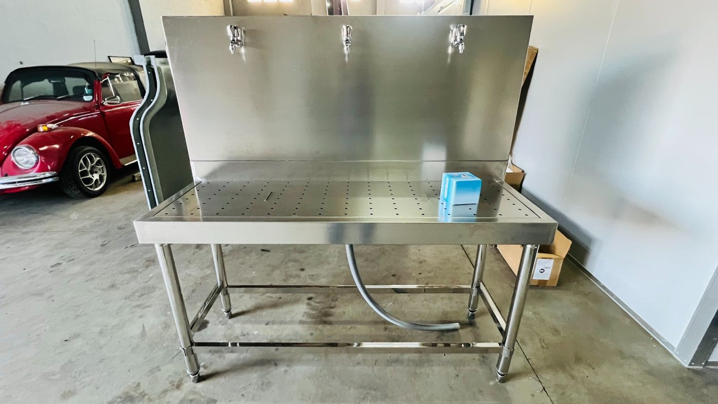 A fabricated stainless-steel station, shown during workshop preparation.