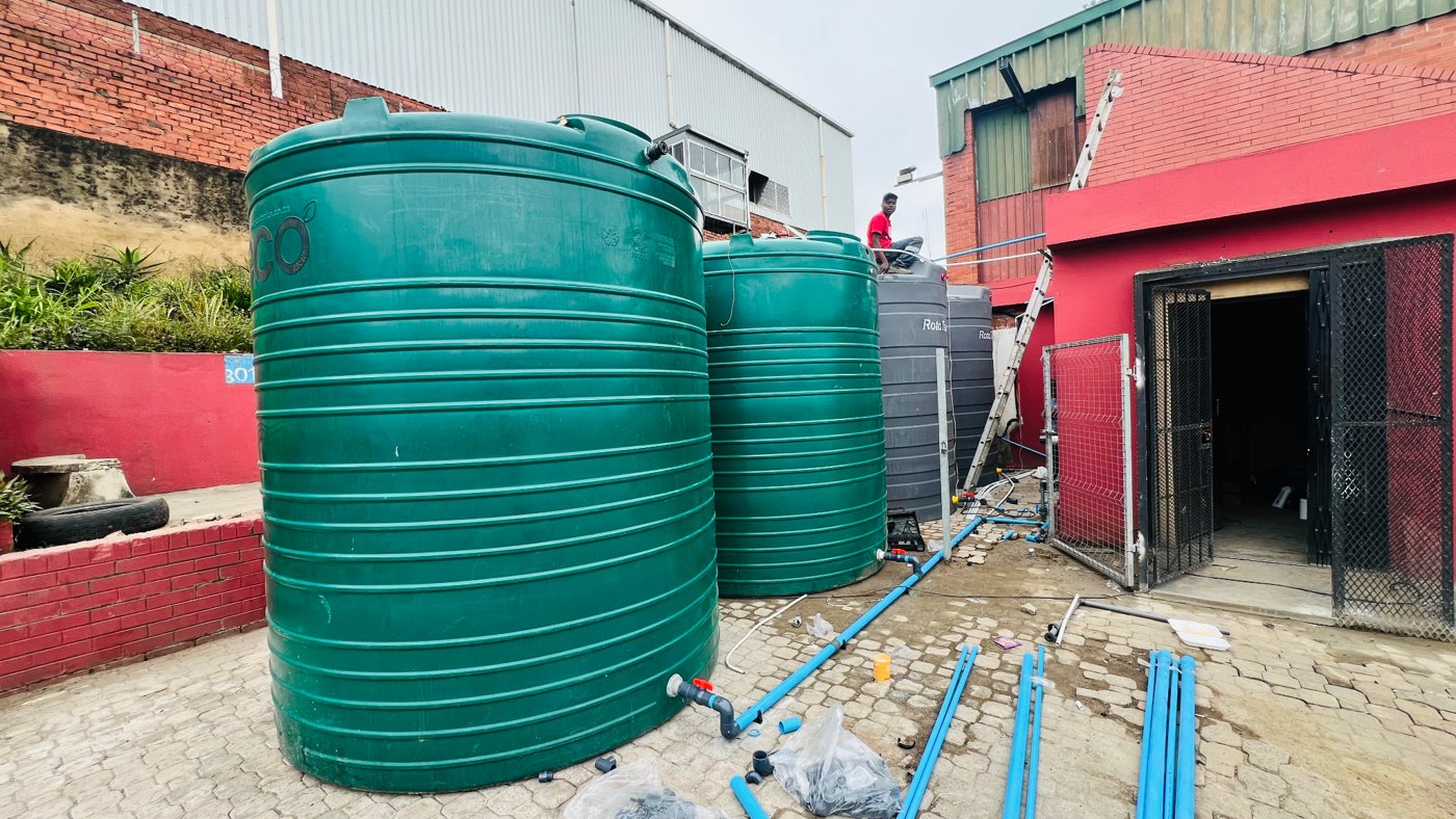A multi-tank installation with connecting pipework, supporting a larger water system.